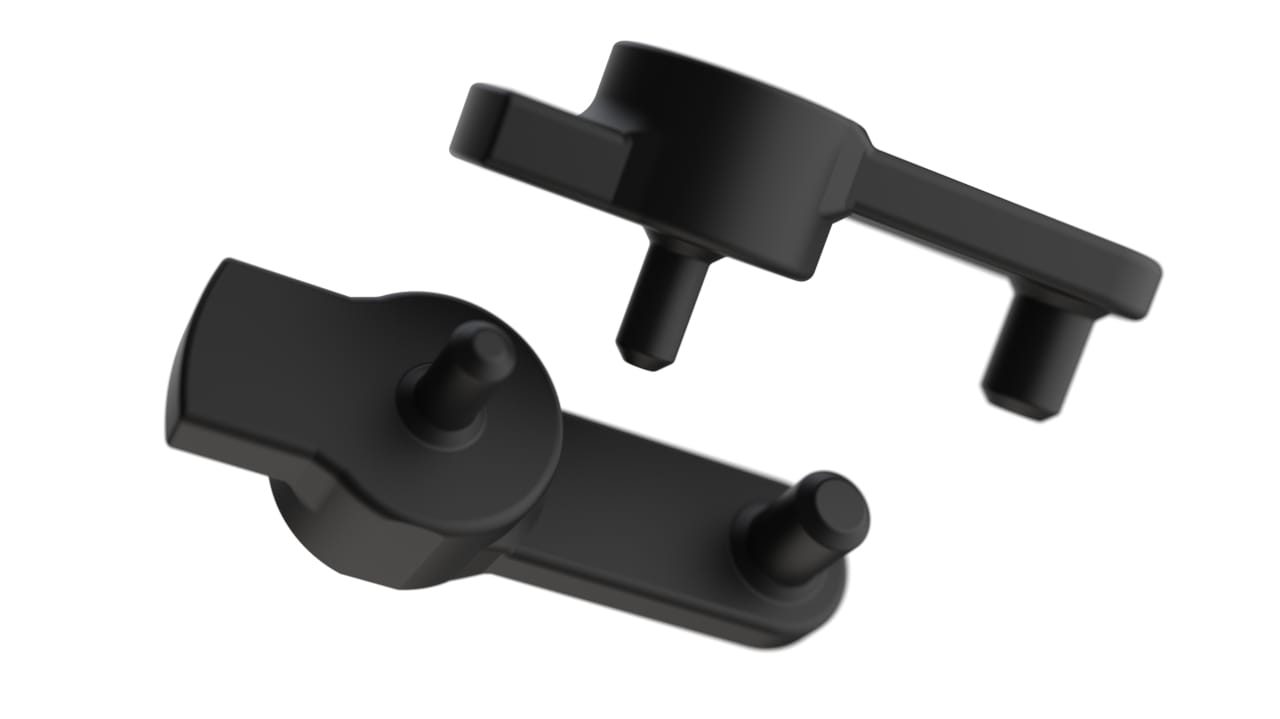 A pair of black plastic handles designed by a Product Design Agency in Swindon, showcased on a white background.