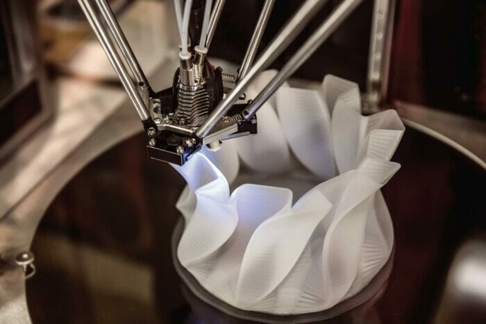 Rapid Prototyping: A 3d printer is being used to make a vase.